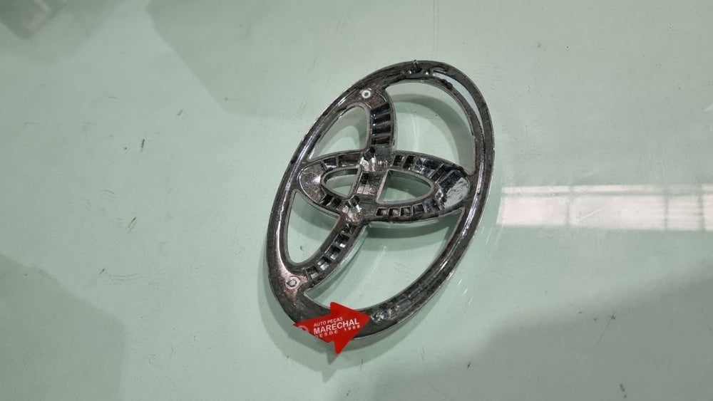 Emblema Diant Toyota Yaris/Hilux 2005/2020