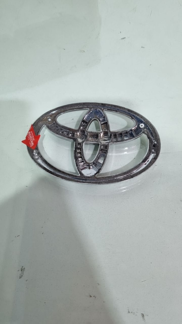 Emblema Diant Toyota Yaris/Hilux 2005/2020