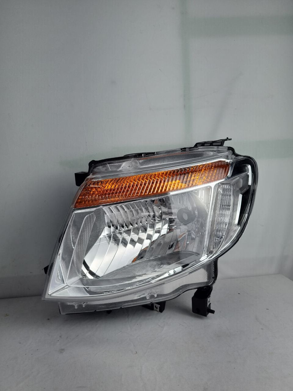 farol principal esquerdo cromado com regulagem manual para
